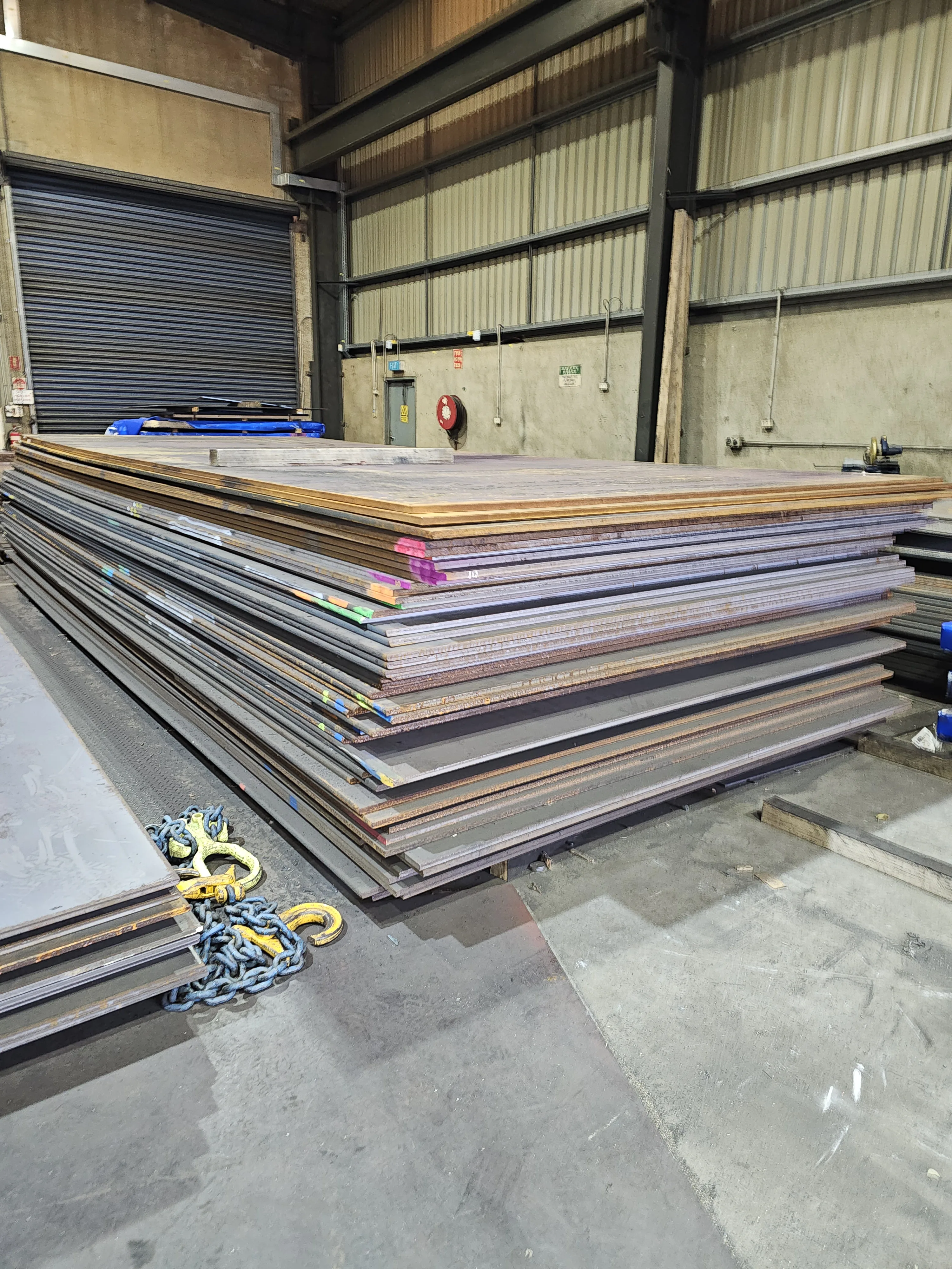 Steel plate stock with lifting chains — M-Steel Dandenong South